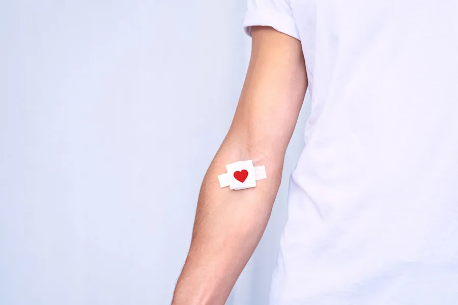 A person's arm with a white shirt and a white background